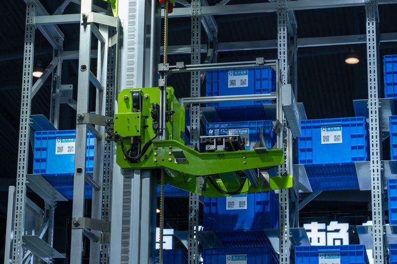 Automated guided vehicle handling totes in warehouse racking