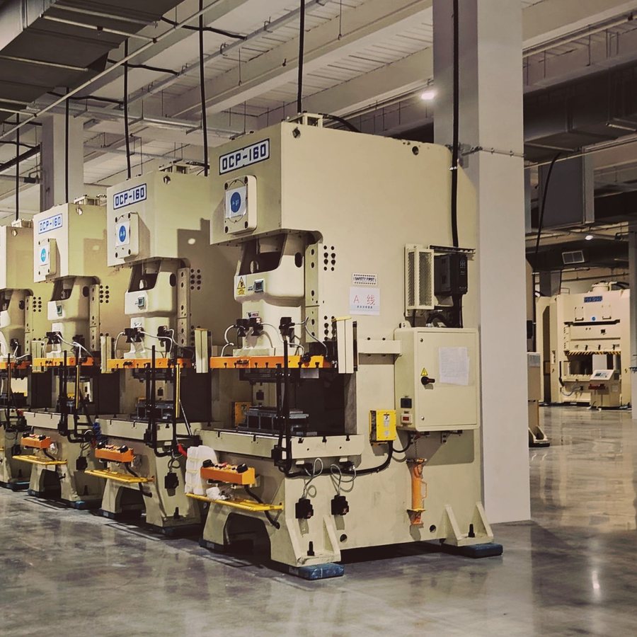 Row of industrial presses on a mill floor