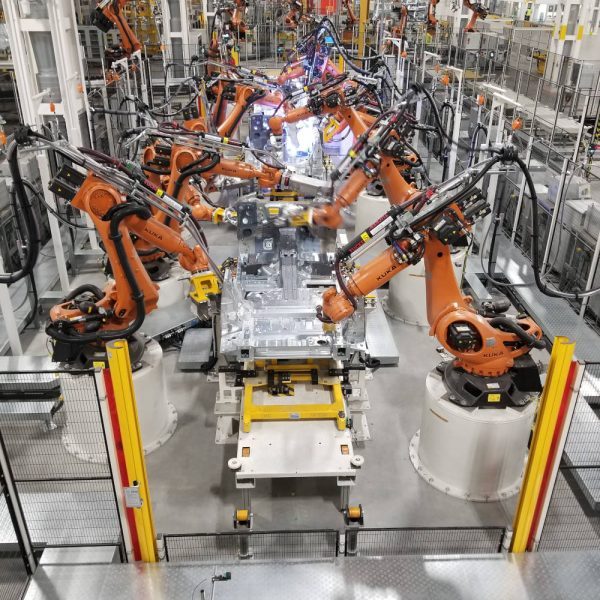 Robots welding a car body on an automotive line