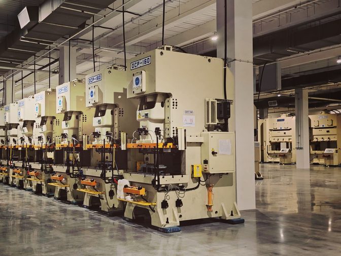Row of industrial presses on a mill floor